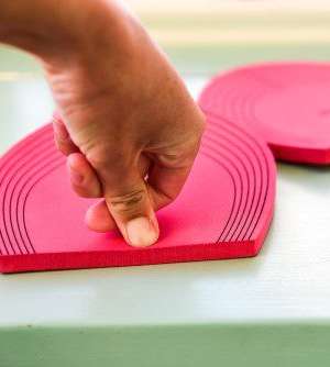 a thumb compresses the bfb cushion pad to show the thick density